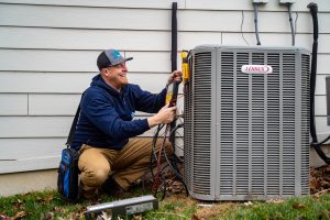 HVAC technician performing post-winter HVAC system evaluation in Manchester, MO