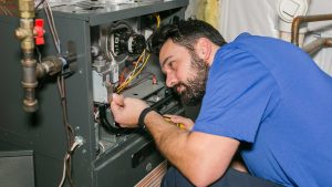 HVAC technician repairing furnace components to restore heating system performance and efficiency